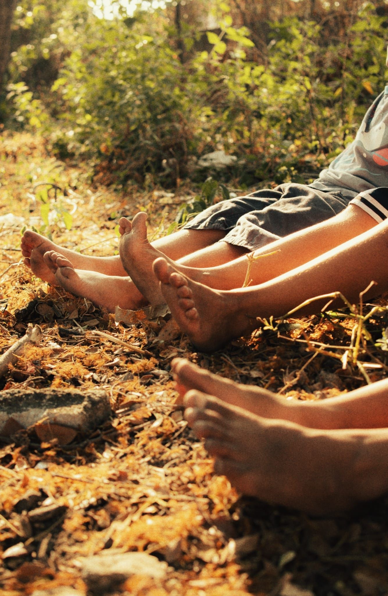 Bare feet resting on dry earth