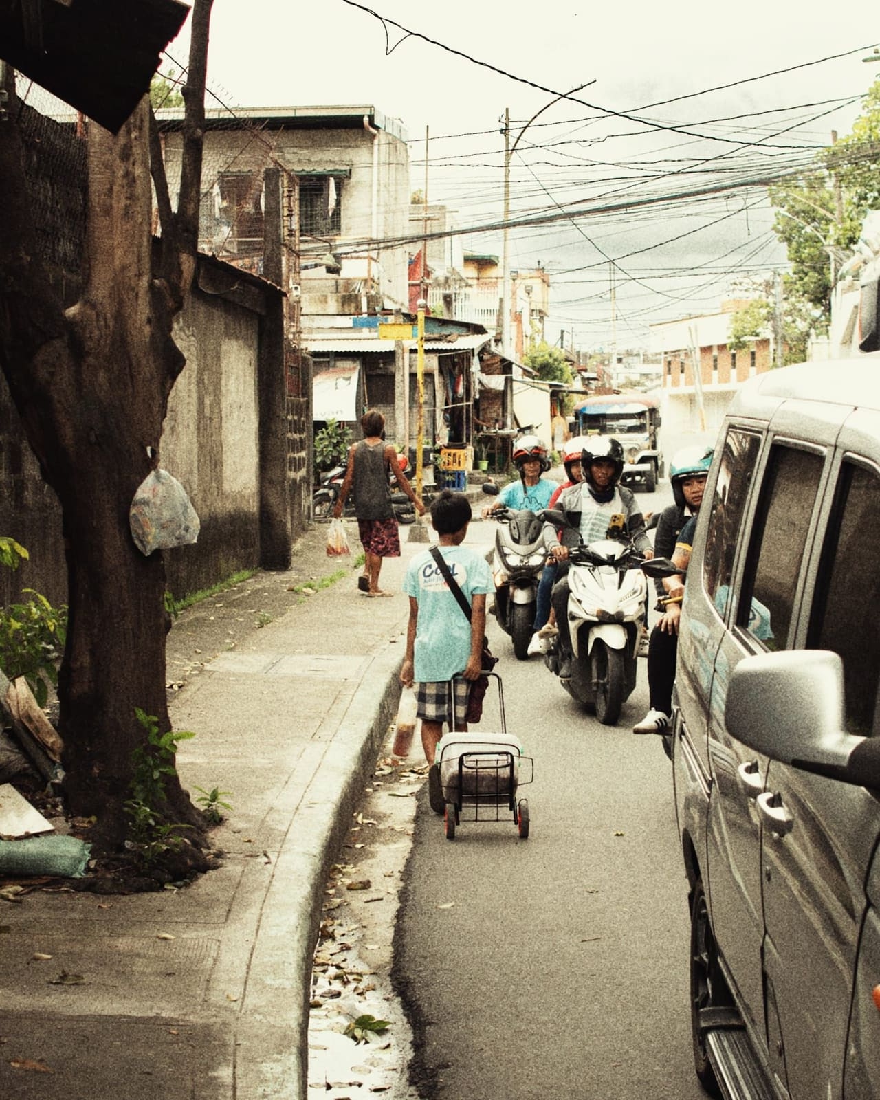 A child walking along a narrow Philippine street